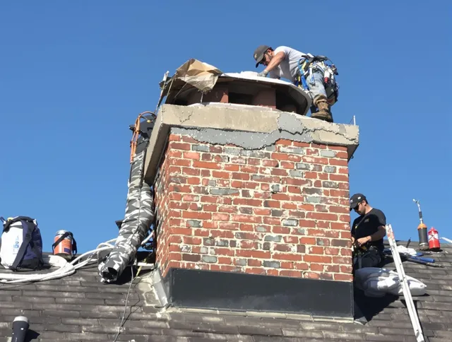 Maynard Chimney Sweep installing a custom chimney crown in Maynard, MA