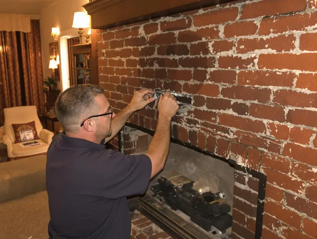 Maynard Chimney Sweep expert fixing a fireplace in Maynard, MA